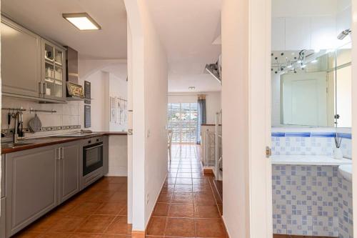 a kitchen with white cabinets and a tile floor at Casa Manuela in Callao Salvaje