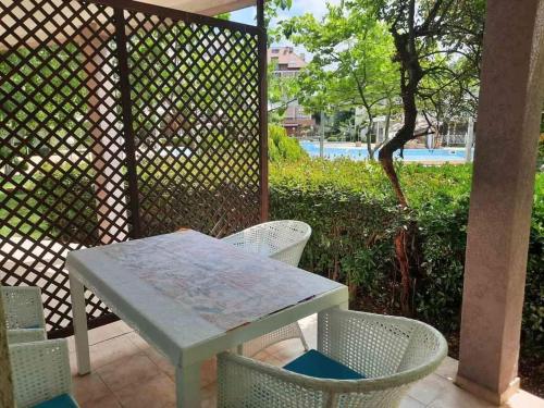 a white table and chairs on a patio at Apartment in Sunny beach, Complex Sun Village, 80 qm, 2 bedrooms & living room near to the beach, SWIMMING POOL, garden in Sunny Beach