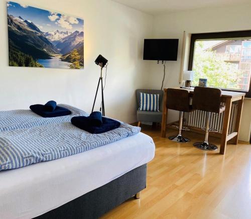 a bedroom with a bed and a desk with a computer at Apartment Colonia in Garmisch-Partenkirchen