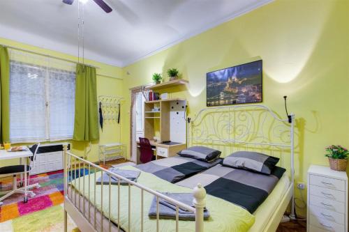 a bedroom with a bed and a desk at Margaret Apartment in Budapest