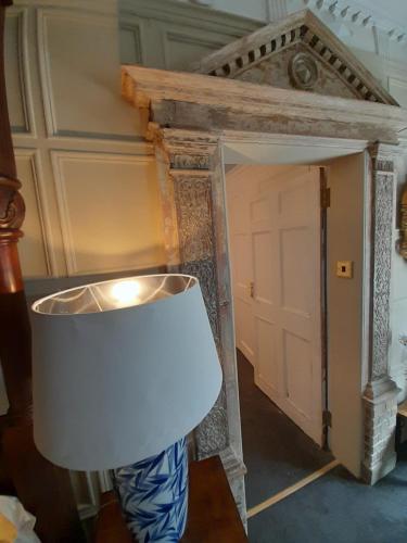 a white lamp in a room with a door at Stone Court House in Maidstone