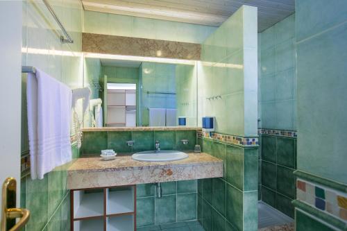a bathroom with a sink and a mirror at Tirreno Resort in Cala Liberotto