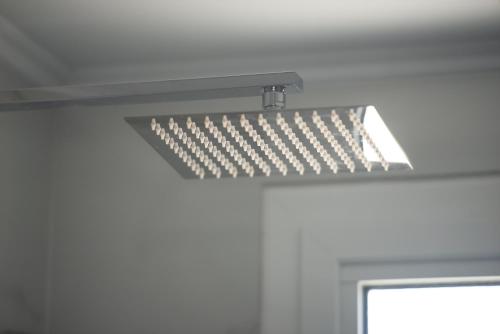 a light hanging from the ceiling of a room at Studios Halkia in Toroni