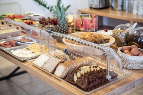 a buffet with different types of food on a table at Artemis Apartments in Stalos