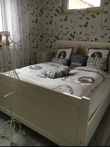 a white bed in a bedroom with a window at Haus-Elbromantik-Sandau in Sandau