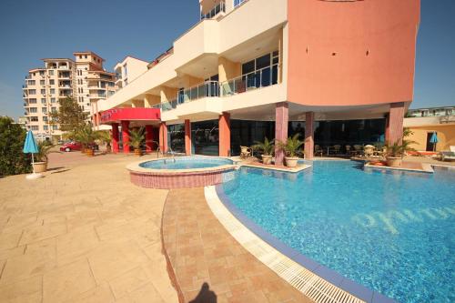a large swimming pool in front of a building at Menada Apartments in Sunny Beach in Sunny Beach