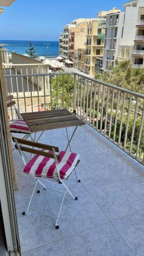 een patio met een tafel en stoelen op een balkon bij Sea view and valley view flat in Marsalforn in Marsalforn