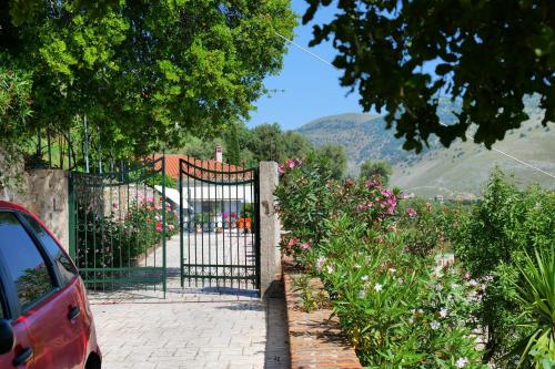 a gate in a garden with flowers at Saranda Landscape in Sarandë