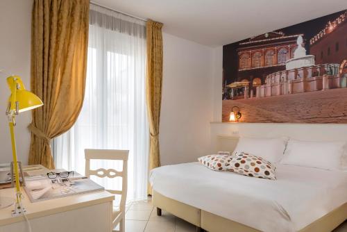 Postel nebo postele na pokoji v ubytování Sovrana Hotel & SPA