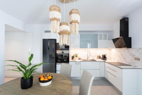 a kitchen with a table with a potted plant at Sersi Paros Villas & Suites in Kampos Paros