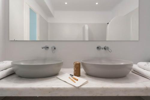 two white sinks on a counter in a bathroom at Sersi Paros Villas & Suites in Kampos Paros