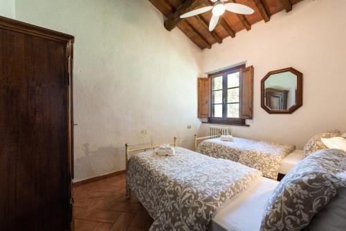 a bedroom with two beds and a mirror at Villa Boscone by Mmega in Querce