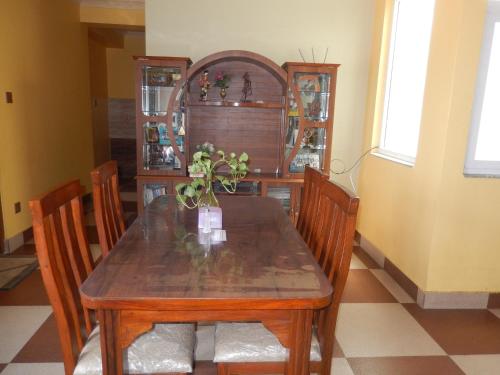 a dining room with a wooden table and chairs at Shine Homestay Famille Francophone - Shine Home and Apartment in Kathmandu