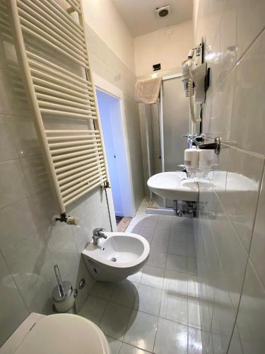 a bathroom with a toilet and a sink at Hotel San Francesco e il lupo in Gubbio