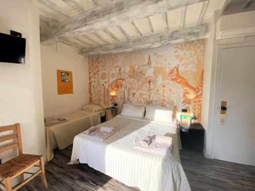 a bedroom with a large white bed in a room at Hotel San Francesco e il lupo in Gubbio