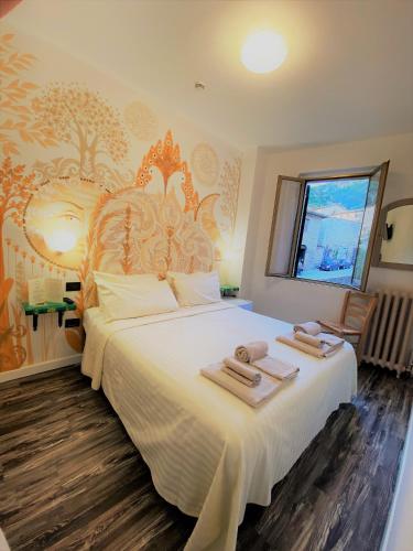 a bedroom with a large bed with towels on it at Hotel San Francesco e il lupo in Gubbio