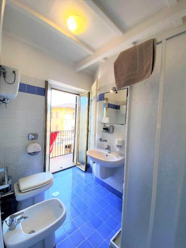 a bathroom with a sink and a toilet and a shower at Hotel San Francesco e il lupo in Gubbio