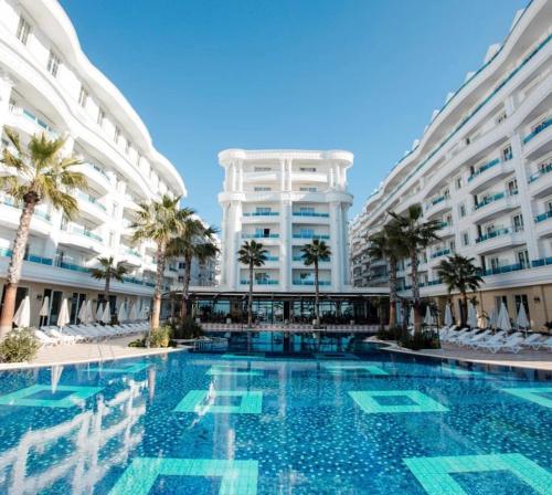 a swimming pool in front of a building at Armando Apartments in Golem