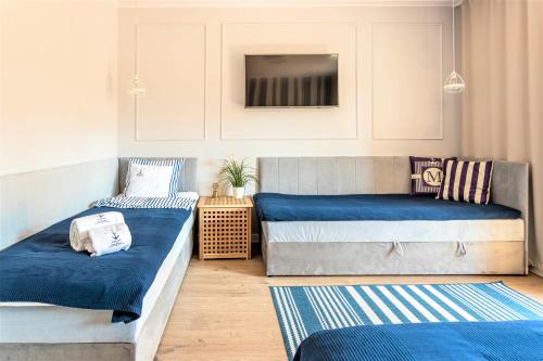 Postel nebo postele na pokoji v ubytování Apartamenty Marynarskie 100m od plaży