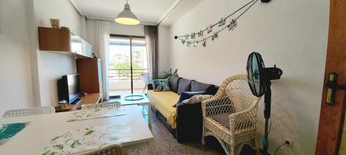 a living room with a couch and a table at Apartament Playa Arenales in Arenales del Sol