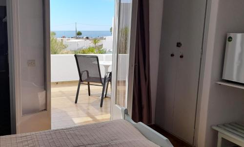a bedroom with a bed and a view of a balcony at Elia in Skala