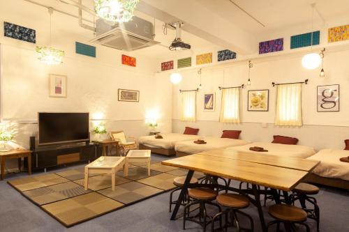 a living room with couches and a table and a tv at VERY in Naha