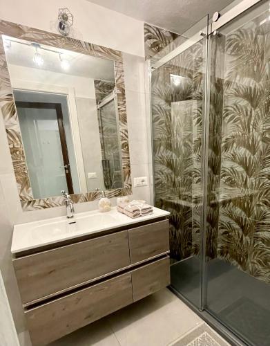 a bathroom with a sink and a shower at APPARTAMENTO PICASSO in Villasimius