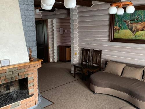 a living room with a couch and a fireplace at Готель Жди ня Єво instagram zhdenievo hotel in Zhdenievo