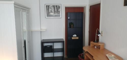a room with a desk and a door with a desk at COSY ROOM IN ANTWERPEN in Mortsel