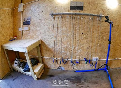 a room with a wall with a pipe and a table at Bike Park Lodge #2 in Merthyr Tydfil