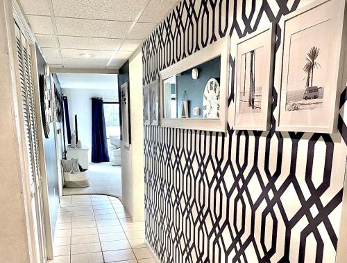 a hallway with a black and white patterned wall at Edgewater RESORT BEACH & GOLF Villa! Steps to the Beach! in Panama City Beach