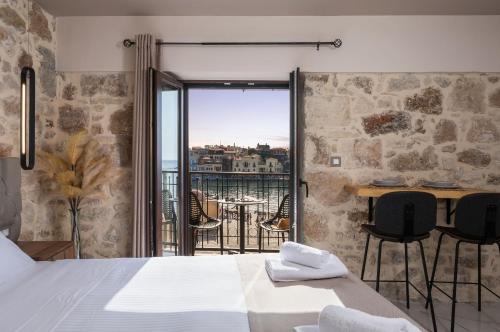 a bedroom with a bed and a balcony with a view at La vista de Pablo in Chania Town