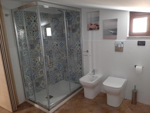a bathroom with a shower and a toilet at Franita in Rossano