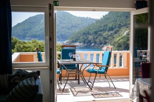 a balcony with a table with a laptop on it at Apartments Stermasi in Saplunara