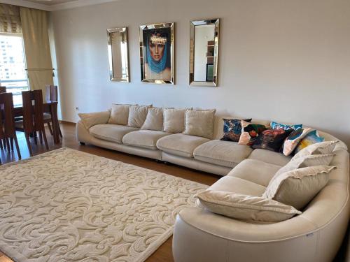 a living room with two couches and a rug at Dream Apartment in Bursa