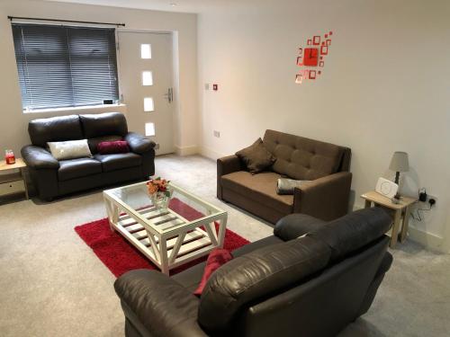 a living room with couches and a coffee table at 08 St Andrews in Lytham St Annes