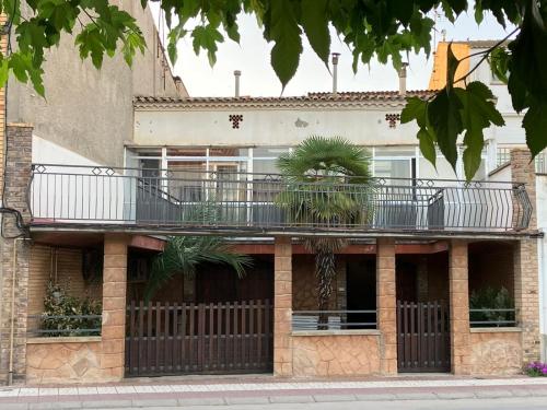 a building with a balcony on the side of it at CAL GUINEU in Vallfogona de Balaguer