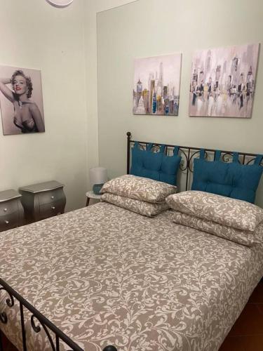 a bedroom with a bed and two pictures on the wall at La Terrazza in Spoleto