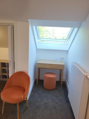 a room with a desk and a chair and a window at Guesthaus 2 in Dudelange
