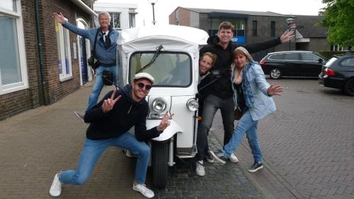 a group of people standing around a small car at Morning Glory in Wemeldinge
