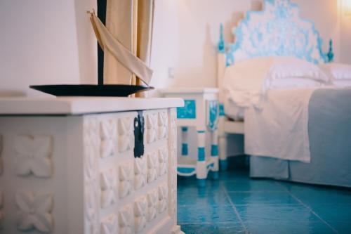 a blue and white bedroom with a bed and a crib at Grand Hotel Le Rocce in Gaeta