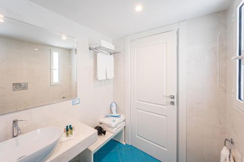 a white bathroom with a sink and a mirror at Grand Hotel Le Rocce in Gaeta