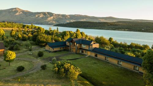 an aerial view of a house with a lake at Lago Rosario Lodge in Trevelin
