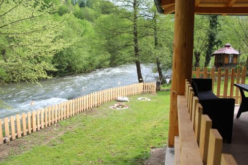 a porch with a gazebo next to a river at Apartman Amina-Ahmad Vinac-Jajce in Jajce