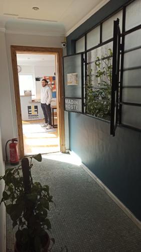 a person standing at the door of a room at Madina Hostel in Cairo
