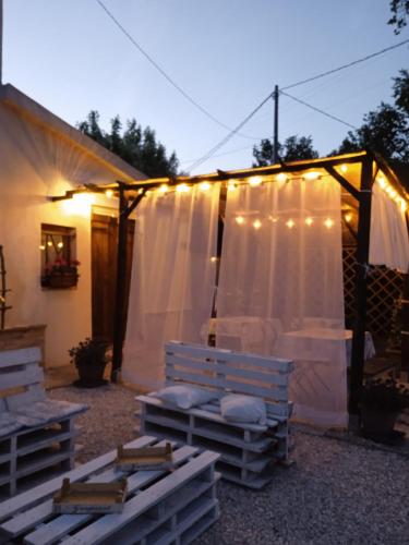 a tent with lights and a bench in a yard at Sotto l'Ulivo in Mondavio