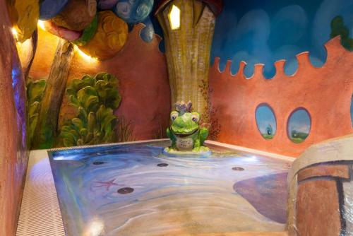 a painting of a frog in a hot tub at Familotel Bavaria Pfronten-Familien Hotel-Alles Inklusive Konzept in Pfronten