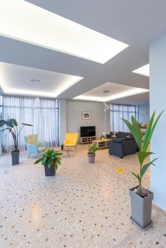 a living room with potted plants on the floor at Vivari Acta in Vivari