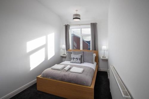 a bedroom with a bed with two towels on it at Family friendly 2-bedroom home in Blackpool in Blackpool