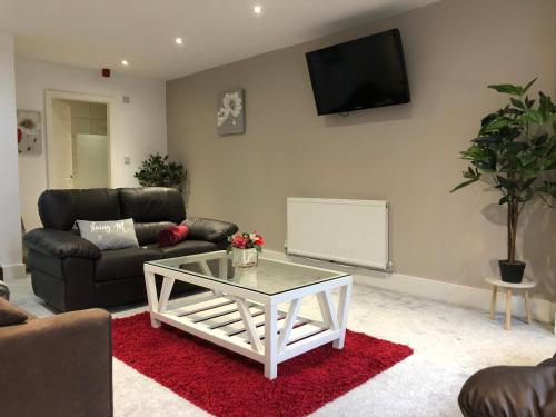 a living room with a couch and a coffee table at 08 St Andrews in Lytham St Annes